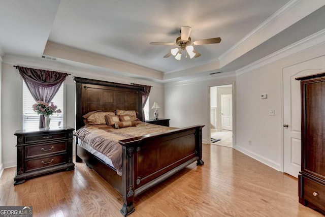25 Kaktovic Ct, Grayson, GA 30017 - bedroom with a raised ceiling, light wood finished floors, ornamental molding, baseboards, and ceiling fan