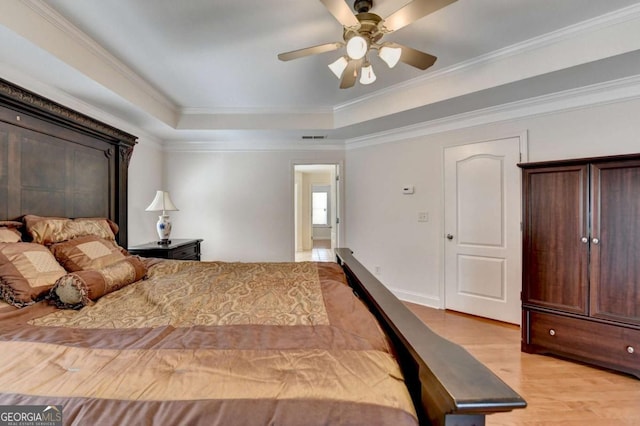 25 Kaktovic Ct, Grayson, GA 30017 - bedroom with light wood finished floors, crown molding, a raised ceiling, and a ceiling fan