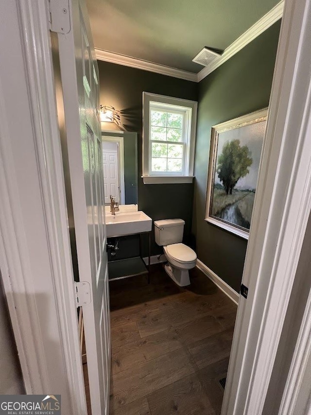 1122 Montclair Dr, Peachtree City, GA 30269 - bathroom with toilet, ornamental molding, vanity, wood finished floors, and baseboards