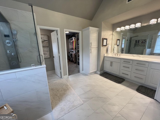 1122 Montclair Dr, Peachtree City, GA 30269 - bathroom featuring marble finish flooring, a shower stall, vanity, lofted ceiling, and a walk in closet