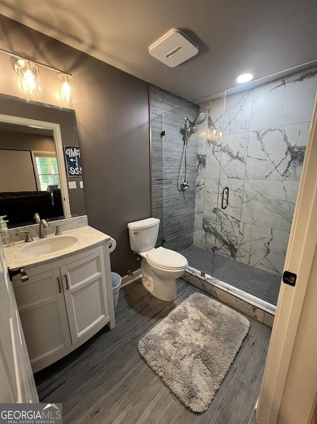 1122 Montclair Dr, Peachtree City, GA 30269 - bathroom with a stall shower, toilet, vanity, wood finish floors, and recessed lighting