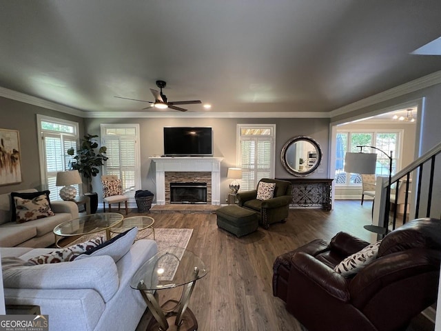 1122 Montclair Dr, Peachtree City, GA 30269 - living room featuring a ceiling fan, a stone fireplace, wood finished floors, plenty of natural light, and crown molding