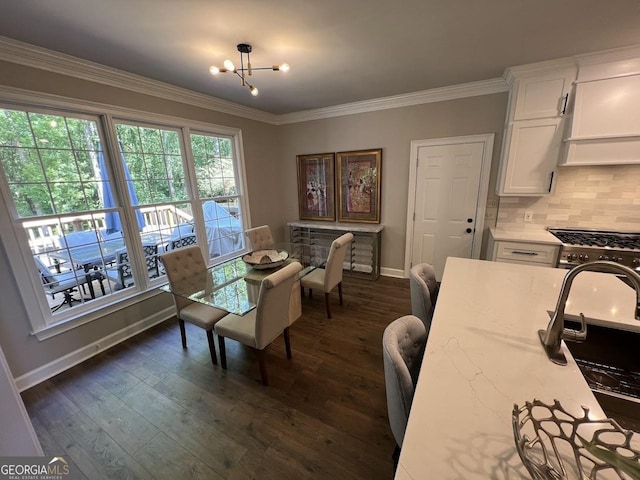 1122 Montclair Dr, Peachtree City, GA 30269 - dining area featuring a chandelier, baseboards, crown molding, and dark wood-type flooring