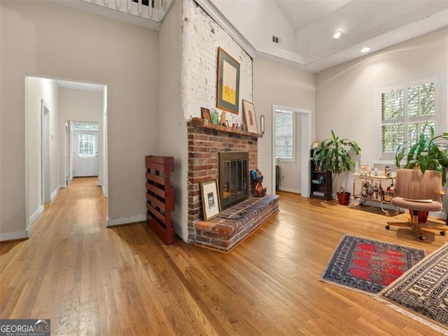 760 Ashland Ave, Atlanta, GA 30307 - living room with light wood-style floors, high vaulted ceiling, a fireplace, recessed lighting, and baseboards