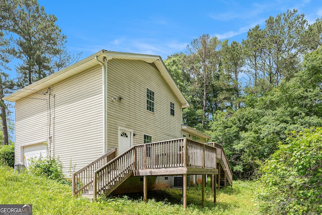 1576 King Mill Rd, Mcdonough, GA 30252 - view of side of home featuring stairway, a deck, and an attached garage