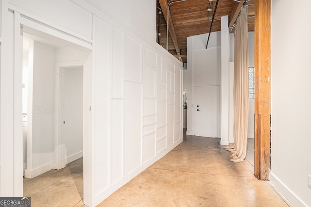 204 Walker St SW Unit 319, Atlanta, GA 30313 - hallway featuring wooden ceiling, finished concrete flooring, vaulted ceiling, and baseboards