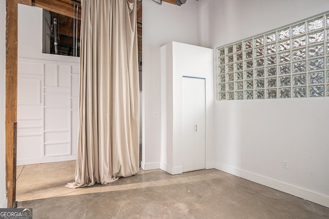 204 Walker St SW Unit 319, Atlanta, GA 30313 - unfurnished bedroom with concrete flooring and baseboards