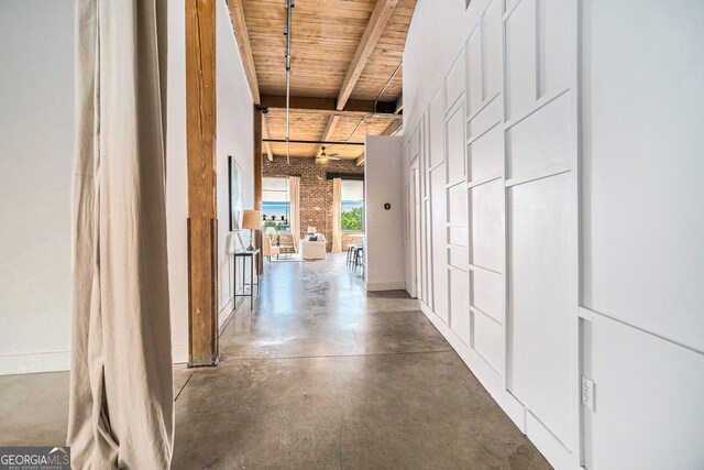 204 Walker St SW Unit 319, Atlanta, GA 30313 - corridor featuring wood ceiling, beamed ceiling, finished concrete floors, and brick wall