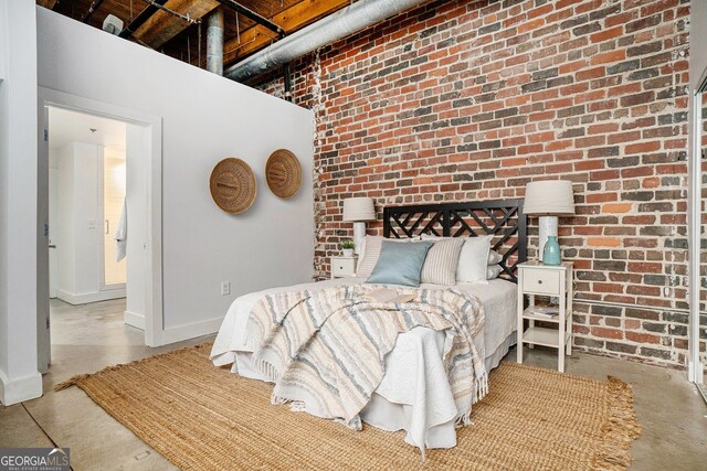 204 Walker St SW Unit 319, Atlanta, GA 30313 - bedroom featuring brick wall, baseboards, concrete floors, and a high ceiling
