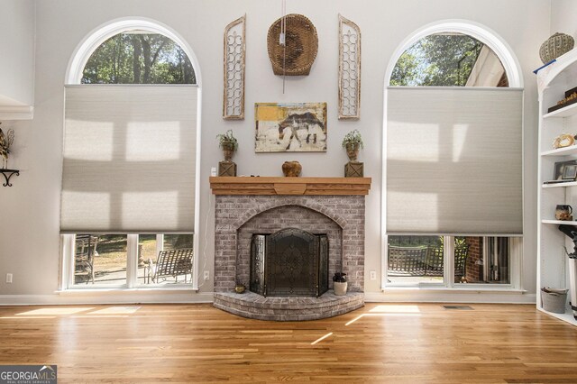 3780 Lovers Ln, Monroe, GA 30656 - unfurnished living room featuring wood finished floors, a fireplace, and built in shelves