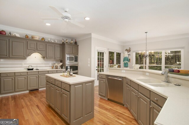 3780 Lovers Ln, Monroe, GA 30656 - kitchen featuring appliances with stainless steel finishes, gray cabinetry, light countertops, ceiling fan, and crown molding