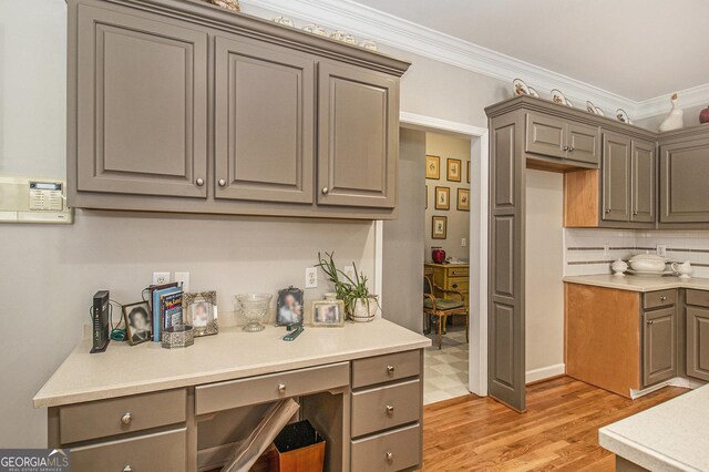 3780 Lovers Ln, Monroe, GA 30656 - kitchen with gray cabinetry, light wood-style flooring, ornamental molding, and light countertops