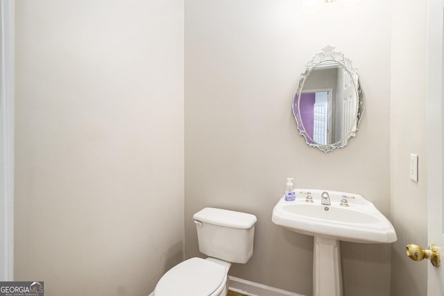 3780 Lovers Ln, Monroe, GA 30656 - bathroom featuring toilet, baseboards, and a sink