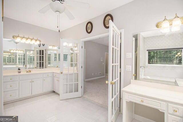 3780 Lovers Ln, Monroe, GA 30656 - full bath featuring french doors, vanity, a garden tub, a ceiling fan, and tile patterned floors