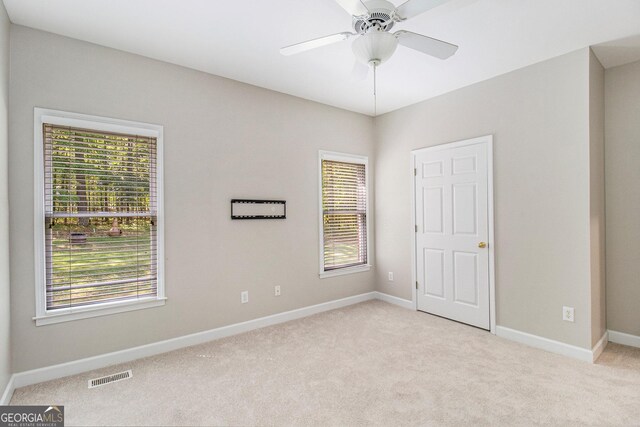 3780 Lovers Ln, Monroe, GA 30656 - unfurnished bedroom featuring light carpet, multiple windows, and baseboards