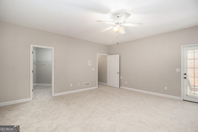3780 Lovers Ln, Monroe, GA 30656 - unfurnished bedroom featuring light carpet, a spacious closet, and baseboards
