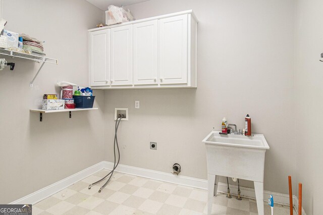 3780 Lovers Ln, Monroe, GA 30656 - washroom with cabinet space, electric dryer hookup, light floors, washer hookup, and baseboards
