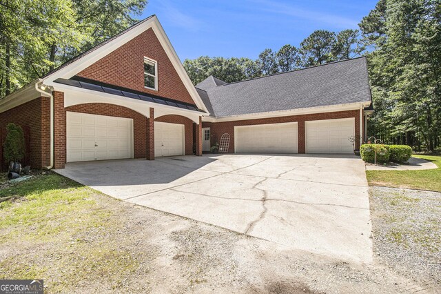 3780 Lovers Ln, Monroe, GA 30656 - view of front facade with brick siding, concrete driveway, and roof with shingles