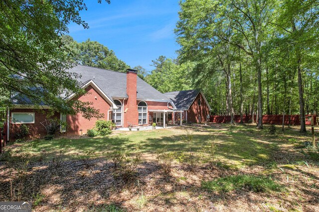 3780 Lovers Ln, Monroe, GA 30656 - back of property featuring brick siding, a chimney, and a patio area