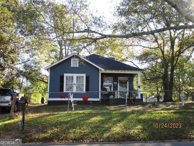 bungalow featuring a fenced front yard and a porch