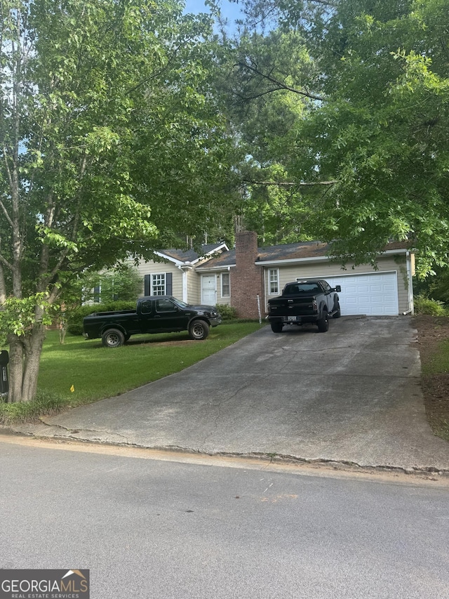 411 Willow Ct SE, Conyers, GA 30094 - view of front facade with a front yard and a chimney