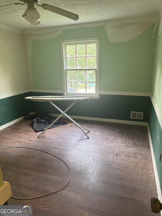 411 Willow Ct SE, Conyers, GA 30094 - unfurnished bedroom with baseboards, a textured ceiling, and ceiling fan
