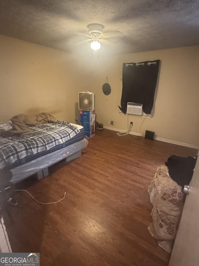 411 Willow Ct SE, Conyers, GA 30094 - bedroom with wood finished floors, baseboards, a textured ceiling, and ceiling fan