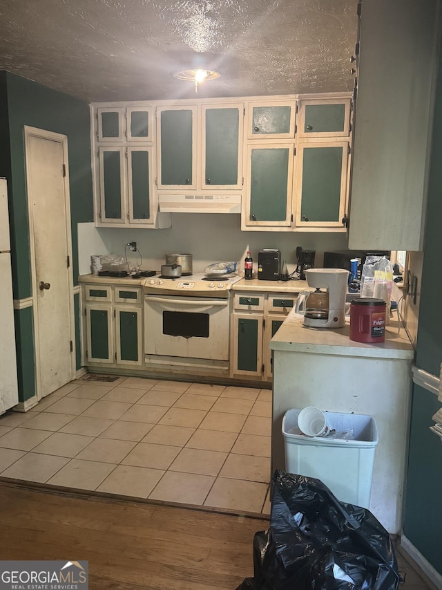 411 Willow Ct SE, Conyers, GA 30094 - kitchen with white appliances, light countertops, under cabinet range hood, a textured ceiling, and glass insert cabinets