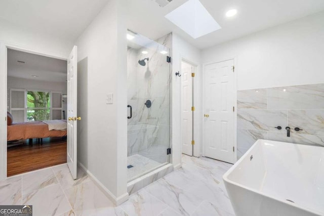 4411 Paces Battle NW, Atlanta, GA 30327 - ensuite bathroom featuring marble look tile flooring, a freestanding bath, a skylight, a marble finish shower, and recessed lighting
