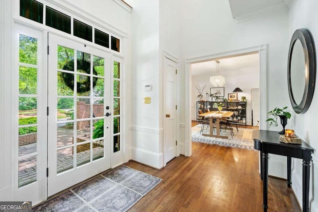 4411 Paces Battle NW, Atlanta, GA 30327 - entryway with crown molding, wood finished floors, and a chandelier