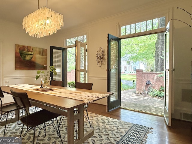 4411 Paces Battle NW, Atlanta, GA 30327 - dining area featuring crown molding, wood finished floors, and a chandelier