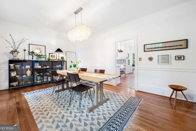 4411 Paces Battle NW, Atlanta, GA 30327 - dining area with crown molding, a chandelier, and wood finished floors