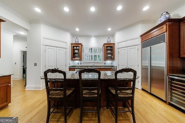 4470 Crestwicke Pointe, Atlanta, GA 30319 - kitchen with stainless steel built in refrigerator, beverage cooler, ornamental molding, glass insert cabinets, and stone counters