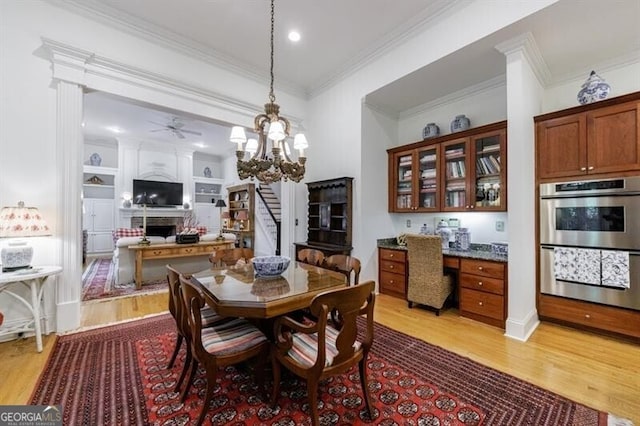 4470 Crestwicke Pointe, Atlanta, GA 30319 - dining area with light wood-style floors, ornamental molding, ceiling fan, a chandelier, and a fireplace
