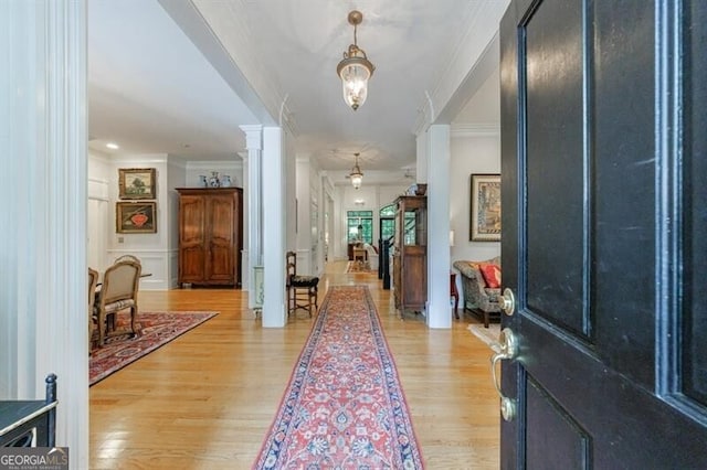 4470 Crestwicke Pointe, Atlanta, GA 30319 - foyer featuring decorative columns, light wood-type flooring, and ornamental molding