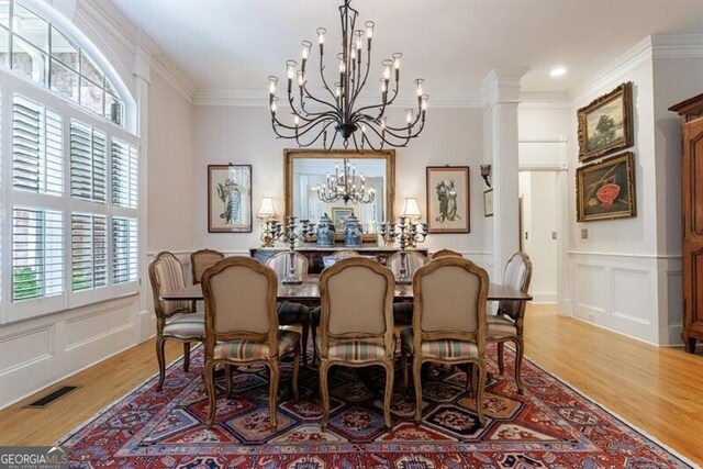 4470 Crestwicke Pointe, Atlanta, GA 30319 - dining space with a chandelier, a decorative wall, ornamental molding, light wood-type flooring, and plenty of natural light