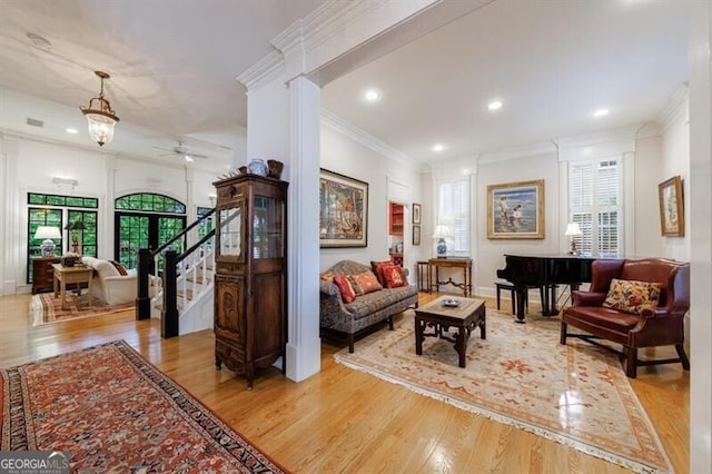 4470 Crestwicke Pointe, Atlanta, GA 30319 - living room with plenty of natural light, a ceiling fan, wood finished floors, crown molding, and stairway
