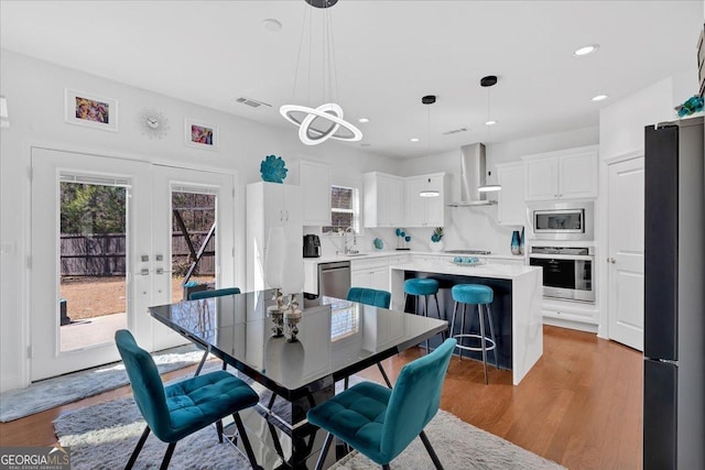138 Lakestone Pkwy, Woodstock, GA 30188 - dining room with healthy amount of natural light, wood finished floors, french doors, recessed lighting, and a chandelier