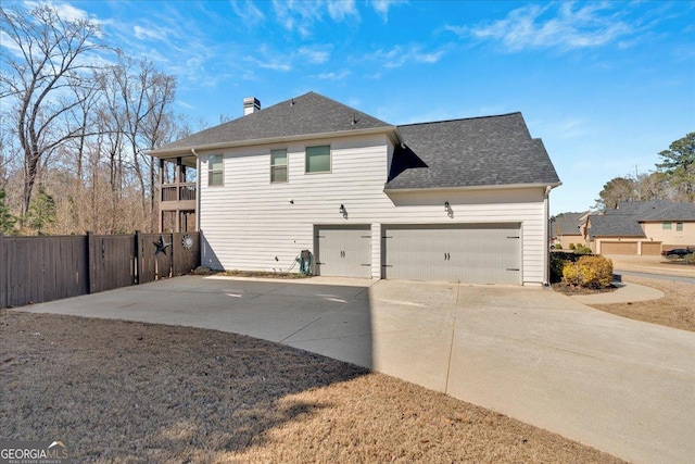 138 Lakestone Pkwy, Woodstock, GA 30188 - back of property featuring driveway, fence, a chimney, and roof with shingles