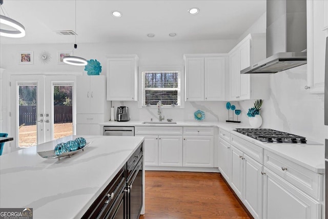 138 Lakestone Pkwy, Woodstock, GA 30188 - kitchen with wall chimney range hood, a sink, appliances with stainless steel finishes, white cabinetry, and recessed lighting