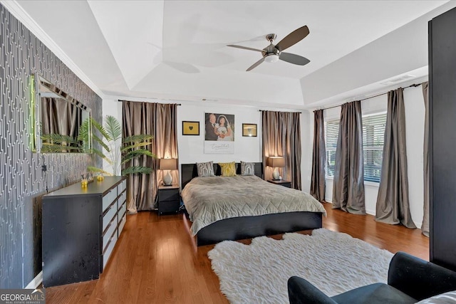 138 Lakestone Pkwy, Woodstock, GA 30188 - bedroom with a tray ceiling, wood finished floors, and a ceiling fan