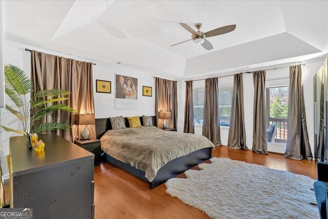 138 Lakestone Pkwy, Woodstock, GA 30188 - bedroom featuring a tray ceiling, wood finished floors, access to outside, and a ceiling fan