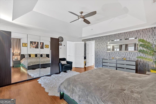 138 Lakestone Pkwy, Woodstock, GA 30188 - bedroom with a raised ceiling, wallpapered walls, wood finished floors, and ceiling fan