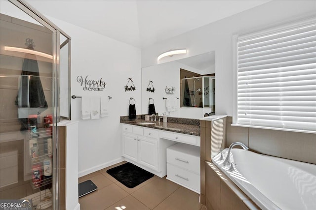 138 Lakestone Pkwy, Woodstock, GA 30188 - bathroom featuring a stall shower, tile patterned floors, vanity, and a garden tub