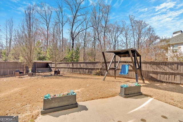 138 Lakestone Pkwy, Woodstock, GA 30188 - fenced backyard with a playground and a patio area