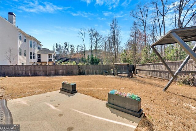 138 Lakestone Pkwy, Woodstock, GA 30188 - fenced backyard with a patio area
