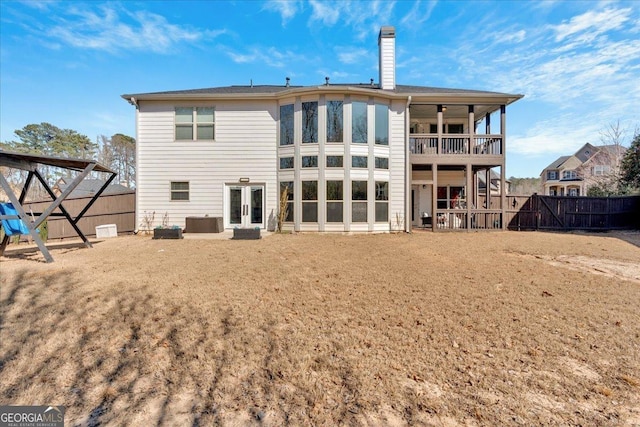 138 Lakestone Pkwy, Woodstock, GA 30188 - rear view of house with french doors, a fenced backyard, a chimney, and a balcony