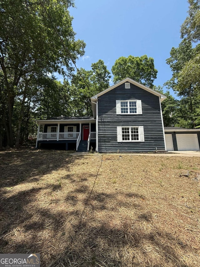 view of front facade with covered porch and a garage