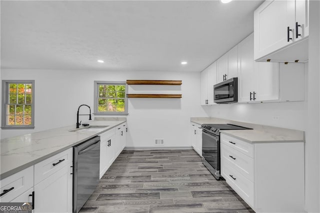 5200 Beechwood Forest Ct, Lithonia, GA 30038 - kitchen with stainless steel appliances, open shelves, light stone counters, recessed lighting, and white cabinetry