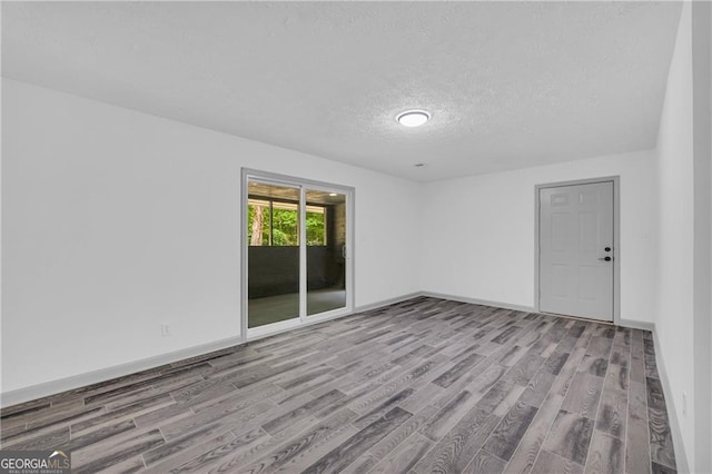5200 Beechwood Forest Ct, Lithonia, GA 30038 - spare room with wood finished floors and a textured ceiling